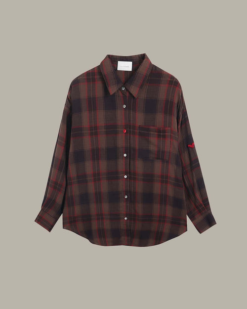 Plaid shirt with red and black pattern on a beige background
