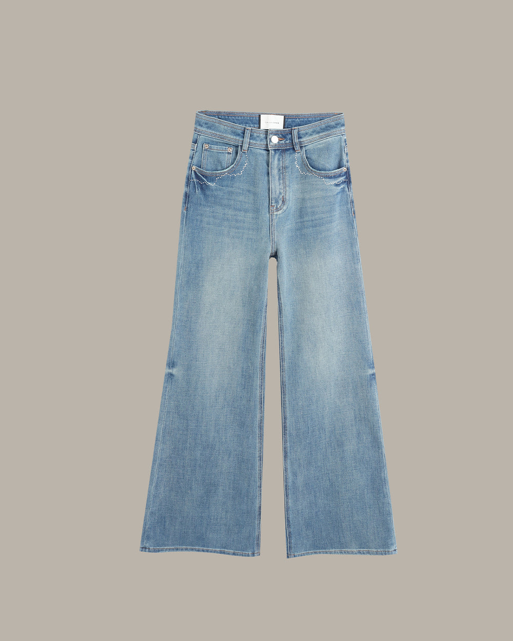 Light blue wide-leg denim jeans with a faded wash, displayed flat against a solid taupe background.