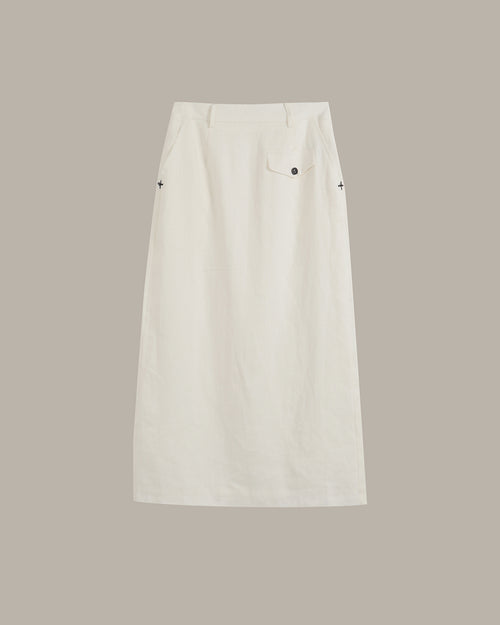 An off-white skirt with a single front patch pocket and small black embroidered star details on the sides, shown flat against a solid taupe background.