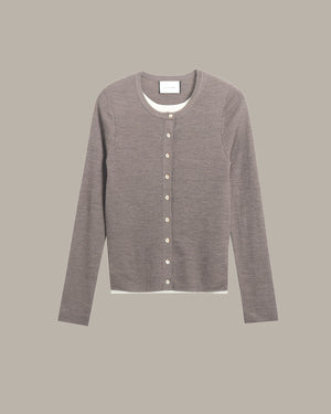 A long-sleeve crewneck cardigan sweater in a heathered taupe-gray color, featuring a button-up front with light-colored buttons and a visible white inner collar, displayed against a solid taupe-gray background.