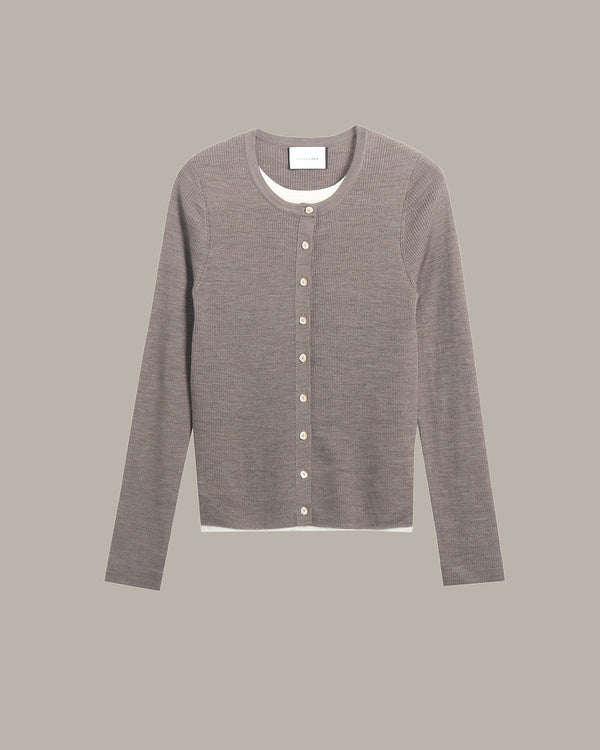 A long-sleeve crewneck cardigan sweater in a heathered taupe-gray color, featuring a button-up front with light-colored buttons and a visible white inner collar, displayed against a solid taupe-gray background.