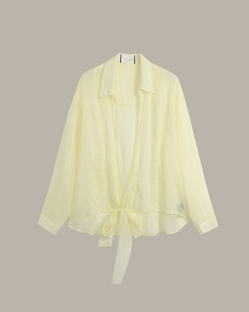 A pale yellow lightweight open-front cardigan with a collar, long sleeves, and a tie detail at the hem, displayed against a solid taupe background.