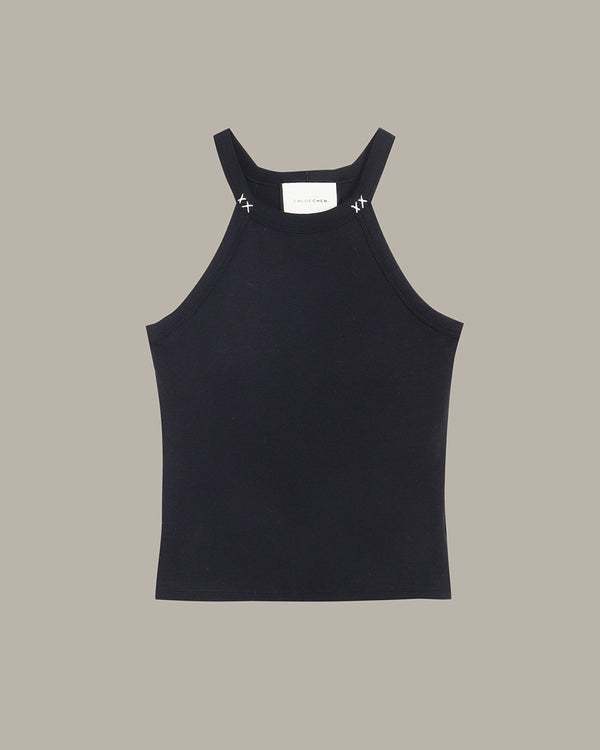 Black tank top on a beige background