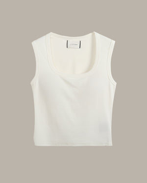 White sleeveless top on a beige background