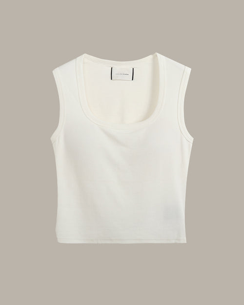 White sleeveless top on a beige background