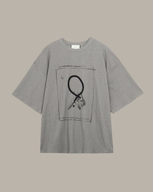 Gray t-shirt with a key pattern graphic design on a beige background