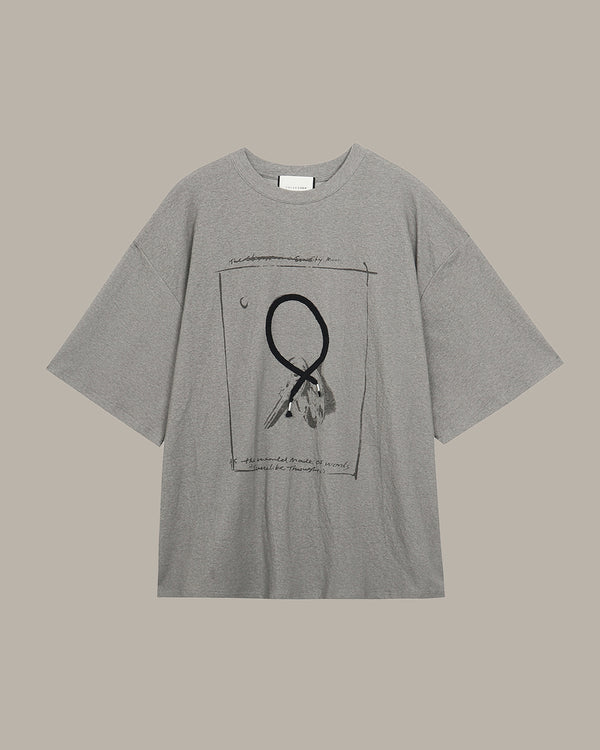 Gray t-shirt with a key pattern graphic design on a beige background