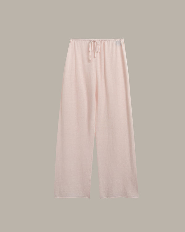 Light pink wide-leg lounge pants with an elastic waistband and drawstring, shown flat against a solid taupe-gray background.