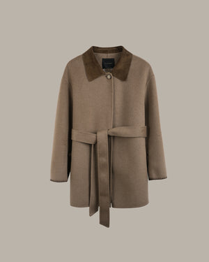 A taupe-brown wool coat with a contrasting dark brown suede collar and a matching waist tie belt, shown against a solid taupe background.