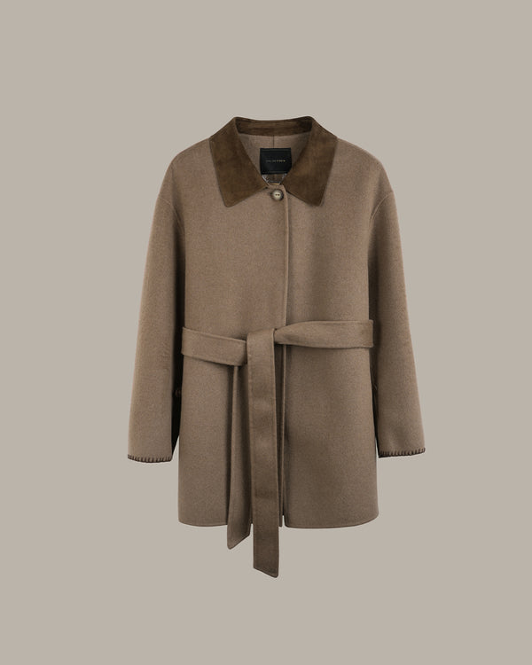 A taupe-brown wool coat with a contrasting dark brown suede collar and a matching waist tie belt, shown against a solid taupe background.