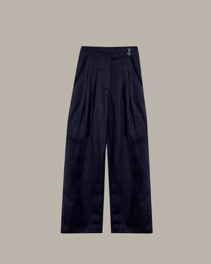 Navy blue pleated pants on a beige background