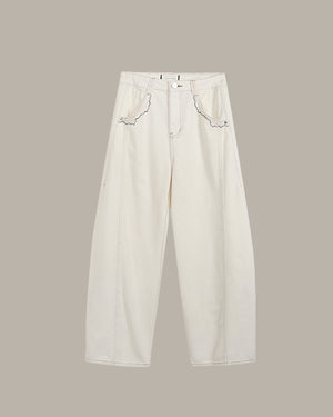 White jeans with lace details on a beige background