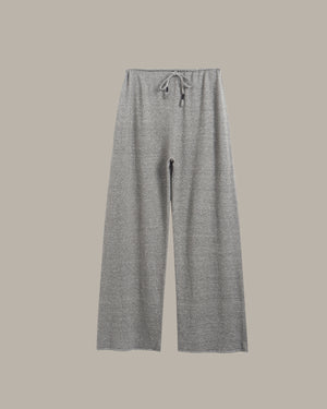 A pair of wide-leg, cropped knit pants in a heather gray color, featuring an elastic waistband with a matching gray drawstring, shown against a solid taupe background.