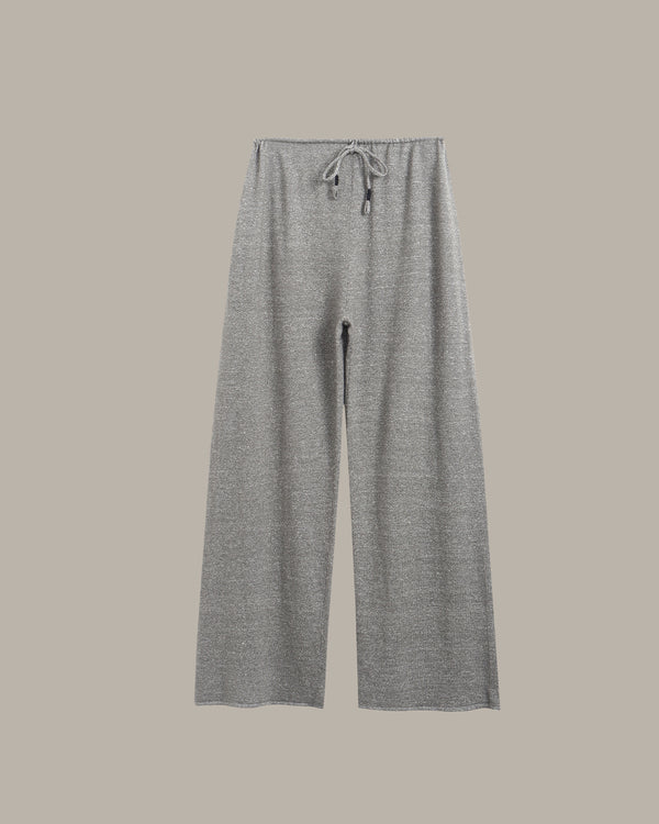 A pair of wide-leg, cropped knit pants in a heather gray color, featuring an elastic waistband with a matching gray drawstring, shown against a solid taupe background.
