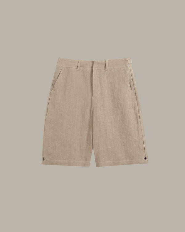 Beige linen shorts with a flat front and side pockets, displayed flat against a solid taupe background.