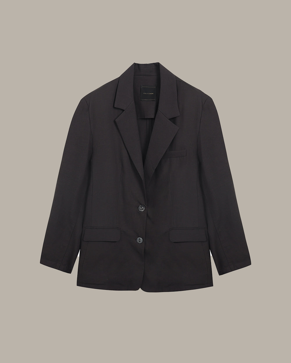 Black blazer on a beige background