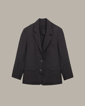 Black blazer on a beige background