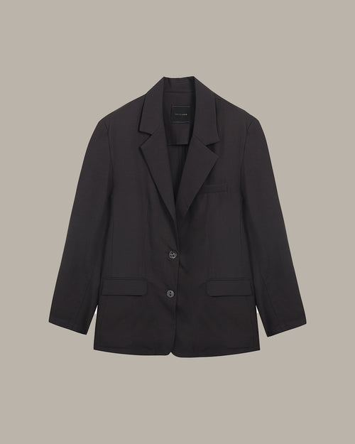 Black blazer on a beige background