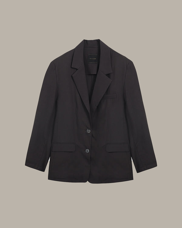 Black blazer on a beige background