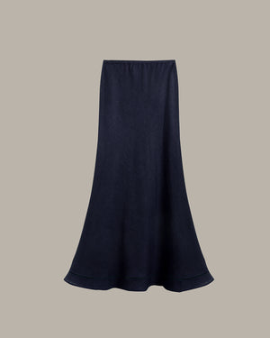 A dark navy blue midi skirt with a flared silhouette, displayed against a solid taupe-gray background.