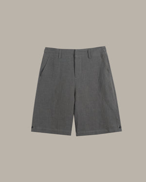 A pair of dark gray textured shorts with belt loops and side pockets, displayed flat against a solid taupe background.