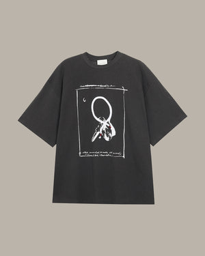 Dark grey t-shirt with white graphic design on a beige background