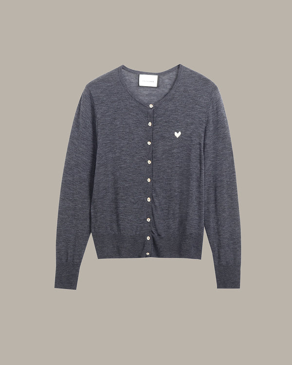 A dark gray heathered knit cardigan sweater with a button-up front, featuring a small white embroidered heart on the left chest, displayed against a solid taupe background.