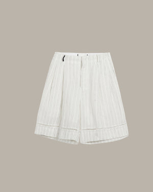 White pleated skirt on a beige background