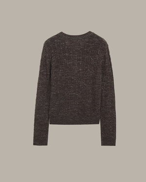 Dark green sweater on a beige background