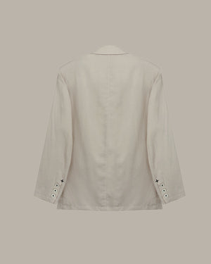 back of a Apricot blazer on a beige background