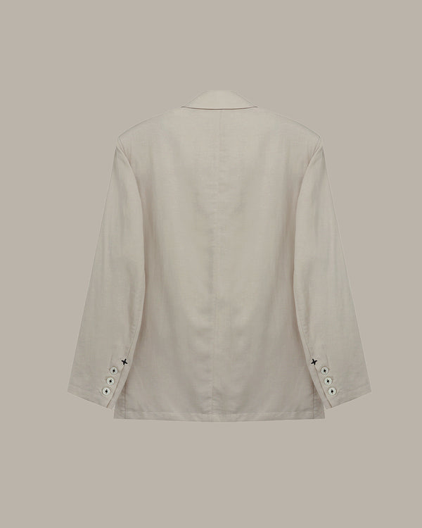 back of a Apricot blazer on a beige background