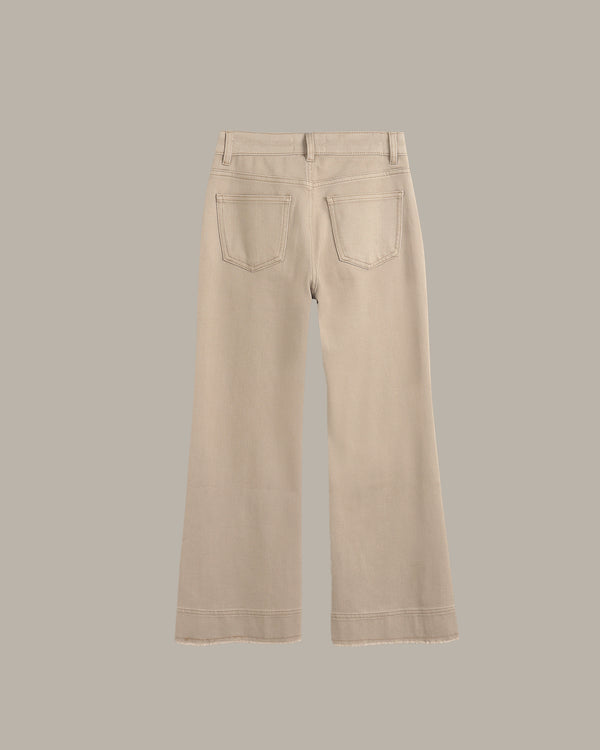A pair of light beige wide-leg jeans shown from the back, featuring two back pockets and a button closure, set against a solid taupe-gray background.