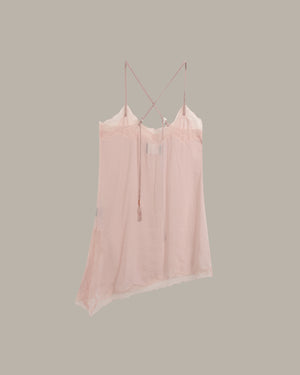 A light pink sheer camisole top with thin straps and a lace-trimmed neckline, shown hanging against a solid taupe-gray background.