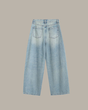 Light blue jeans on a beige background