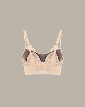 Beige bra with lace details on a gray background