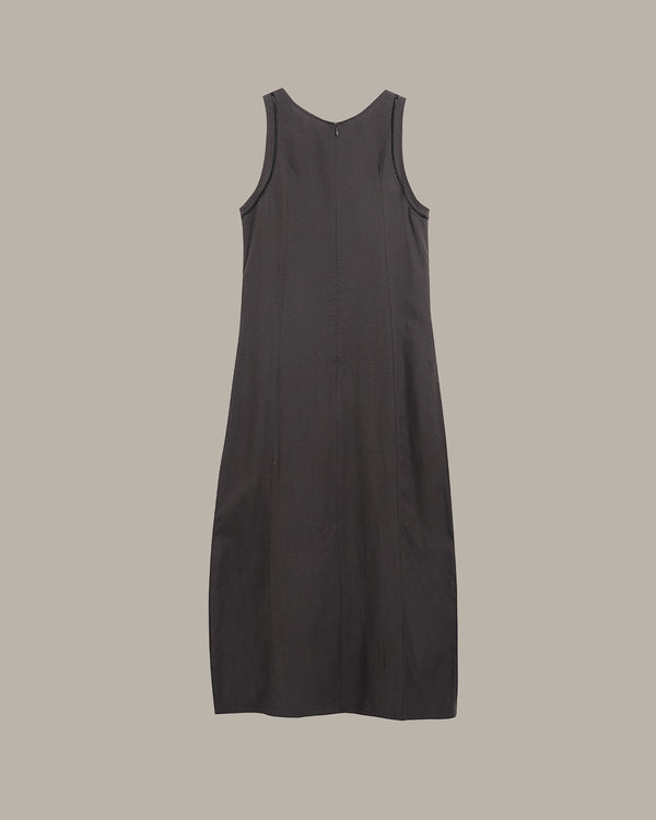 Black sleeveless dress on a beige background