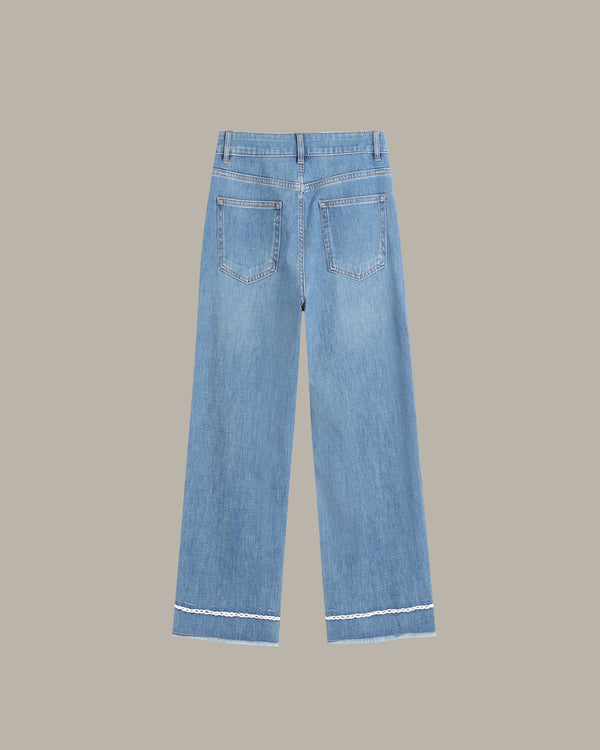 back of a ight blue denim jeans with a straight-to-slightly-relaxed leg, featuring contrast white stitching along the hem and pocket edges, shown against a solid taupe background.