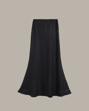 Black skirt on a beige background