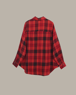 Red and black plaid shirt on a beige background