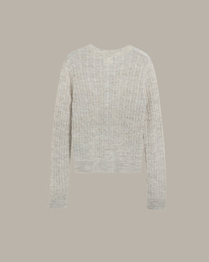 back of a khaki textured sweater on a beige background