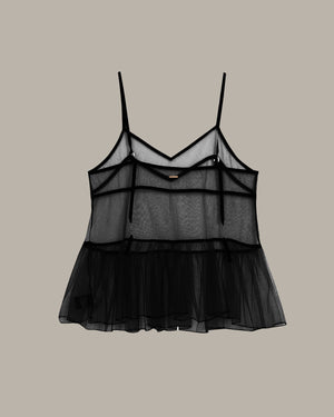 Black sheer top on a beige background