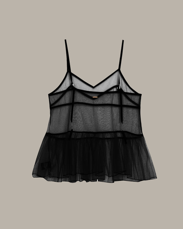 Black sheer top on a beige background