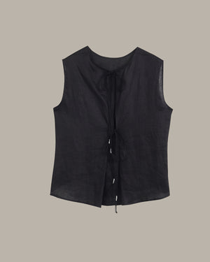 A black sleeveless linen vest with a tie-front closure, displayed flat against a solid taupe background.