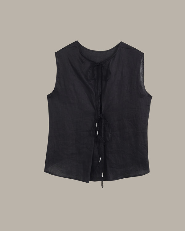 A black sleeveless linen vest with a tie-front closure, displayed flat against a solid taupe background.