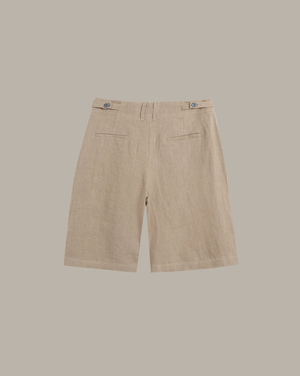 Beige linen shorts with a flat front, belt loops, and two side welt pockets, shown from the back against a solid taupe background.