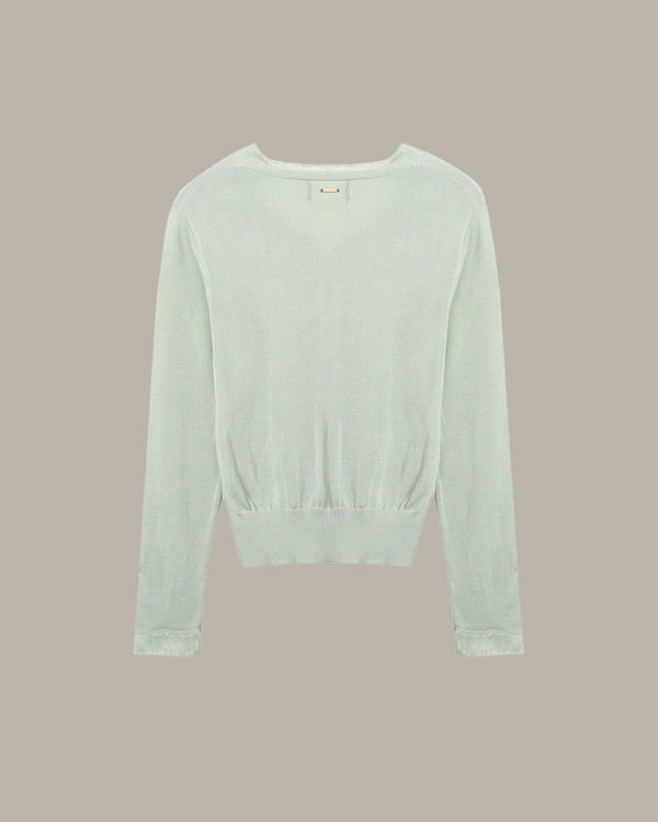 Light green sweater on a beige background