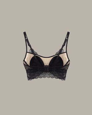 Black lace bra on a beige background