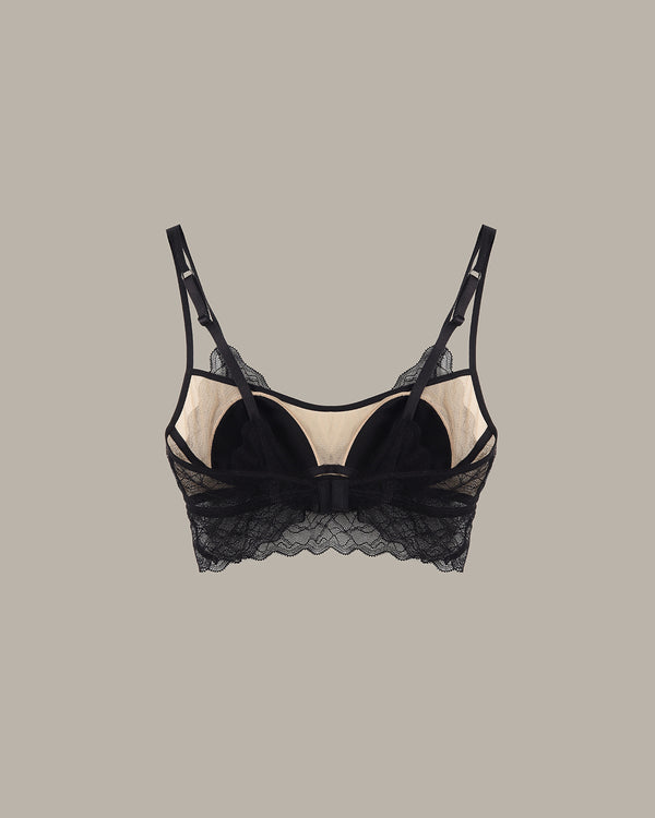Black lace bra on a beige background