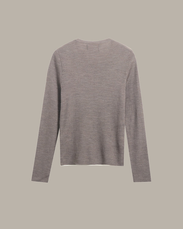 A light gray ribbed knit sweater with long sleeves, shown from the back against a solid taupe background.