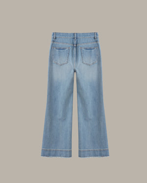 Light blue wide-leg denim jeans shown from the back, featuring two back pockets and a frayed hem, set against a solid taupe background.